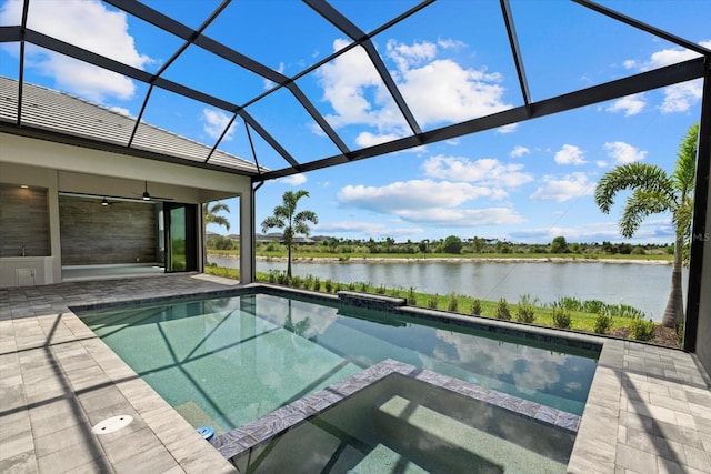 9241 Starry Night Ave, Sarasota, FL 34241 - view of pool featuring a pool with connected hot tub, a water view, a lanai, and a patio area