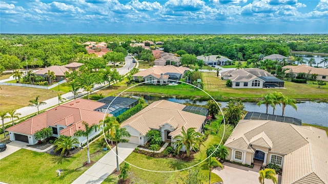 drone / aerial view with a water view and a residential view