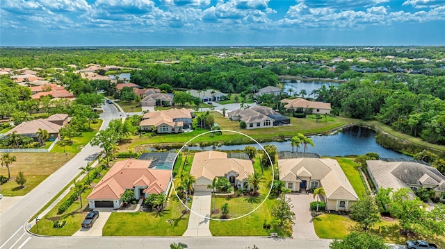 drone / aerial view with a water view and a residential view