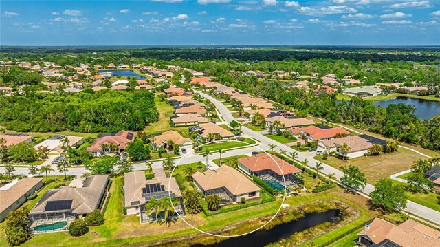 birds eye view of property featuring a residential view and a water view