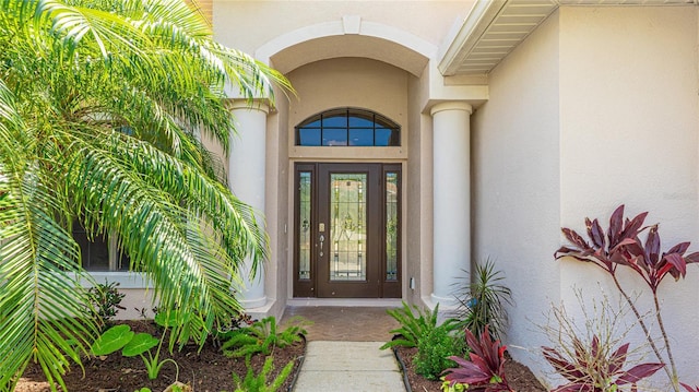 entrance to property featuring stucco siding