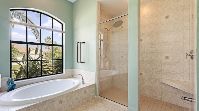 bathroom with a shower stall, plenty of natural light, and a garden tub