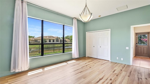 unfurnished bedroom featuring baseboards, a closet, and wood finished floors