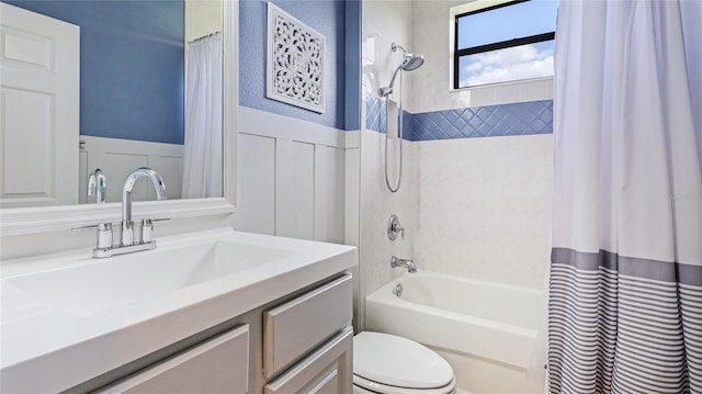 bathroom featuring wainscoting, toilet, vanity, shower / tub combo with curtain, and washer / dryer