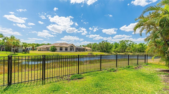 view of yard featuring a water view and fence
