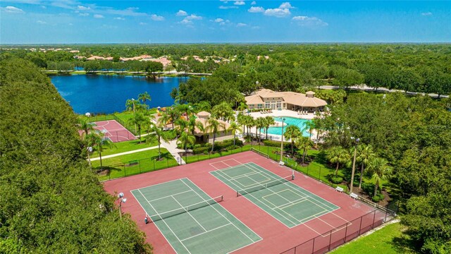 aerial view with a wooded view and a water view
