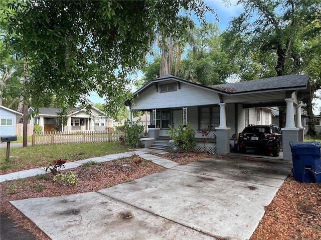 1002 E Ida St, Tampa, FL 33603 - view of front of property featuring an attached carport, covered porch, fence, and concrete driveway