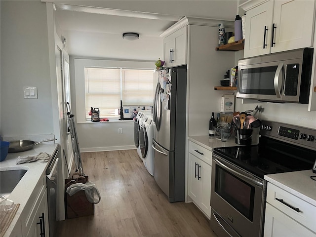 1002 E Ida St, Tampa, FL 33603 - kitchen featuring light countertops, light wood finished floors, stainless steel appliances, and separate washer and dryer