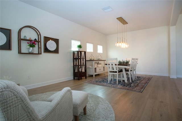 12841 Balsam Ter, Bradenton, FL 34212 - dining space featuring wood finished floors, a chandelier, and baseboards