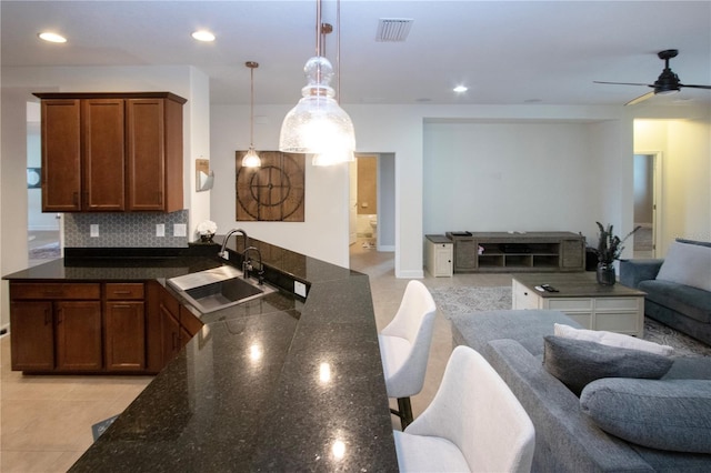 12841 Balsam Ter, Bradenton, FL 34212 - kitchen with open floor plan, a sink, a peninsula, light tile patterned floors, and a ceiling fan