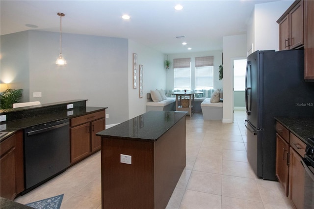 12841 Balsam Ter, Bradenton, FL 34212 - kitchen with black appliances, dark stone countertops, light tile patterned flooring, open floor plan, and recessed lighting