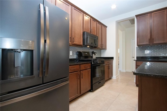 12841 Balsam Ter, Bradenton, FL 34212 - kitchen featuring black appliances, backsplash, dark stone counters, light tile patterned floors, and recessed lighting