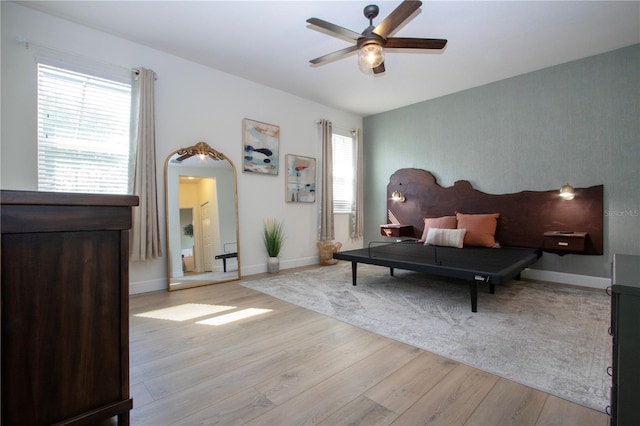 12841 Balsam Ter, Bradenton, FL 34212 - bedroom featuring light wood-style flooring, baseboards, a ceiling fan, and arched walkways