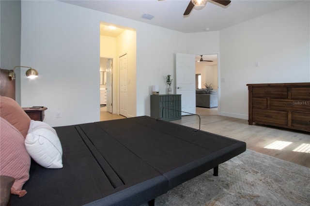 12841 Balsam Ter, Bradenton, FL 34212 - bedroom with light wood finished floors, a ceiling fan, and ensuite bathroom