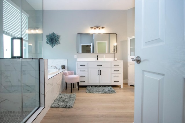 12841 Balsam Ter, Bradenton, FL 34212 - bathroom with wood finished floors, a garden tub, vanity, and a marble finish shower