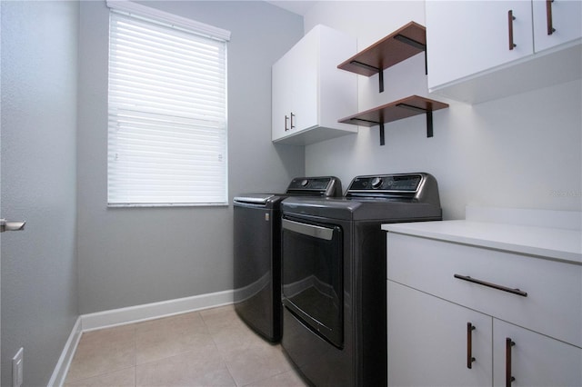 12841 Balsam Ter, Bradenton, FL 34212 - laundry room featuring washer and clothes dryer, cabinet space, baseboards, and light tile patterned floors