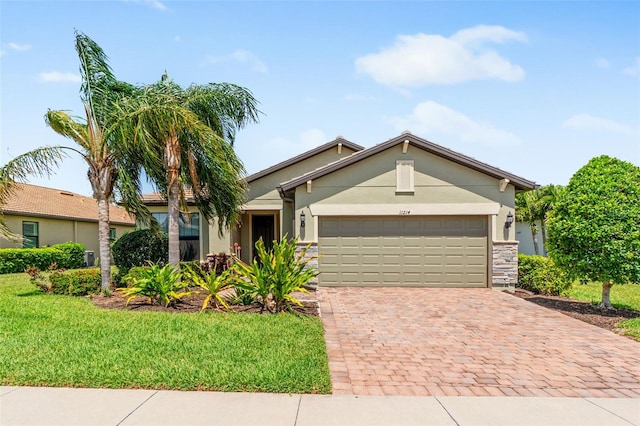 view of front of property with a garage, stucco siding, stone siding, and decorative driveway