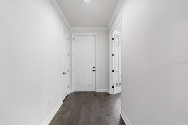 corridor featuring dark wood-type flooring, baseboards, and crown molding