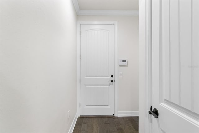 doorway to outside featuring dark wood-type flooring, baseboards, and ornamental molding