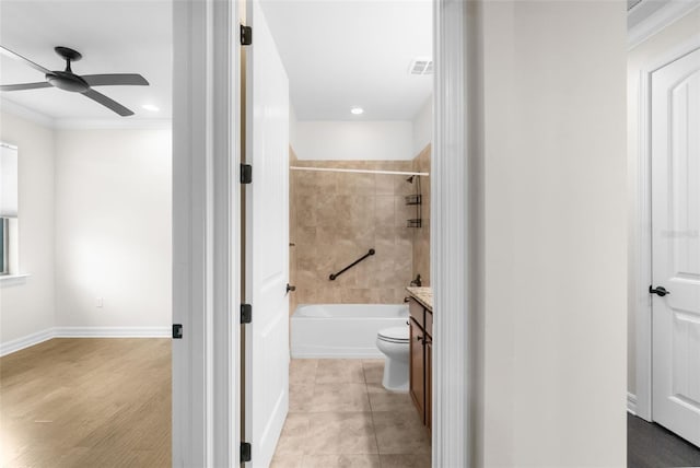 bathroom with vanity, baseboards, a ceiling fan, visible vents, and shower / bathing tub combination