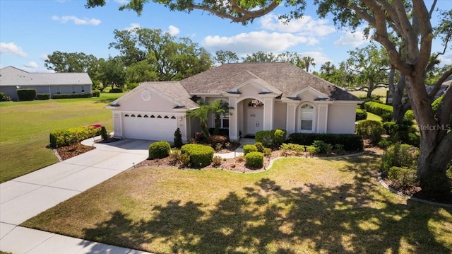 3859 Little Country Rd, Parrish, FL 34219 - view of front facade with a front yard, concrete driveway, stucco siding, and an attached garage