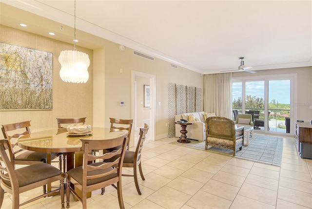 dining room featuring visible vents, crown molding, baseboards, ceiling fan with notable chandelier, and light tile patterned floors