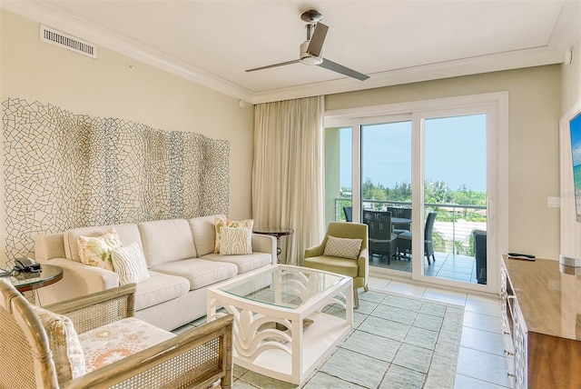 living area featuring light tile patterned flooring, visible vents, crown molding, and ceiling fan