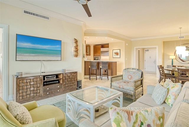 living room featuring a ceiling fan, tile patterned flooring, baseboards, visible vents, and ornamental molding