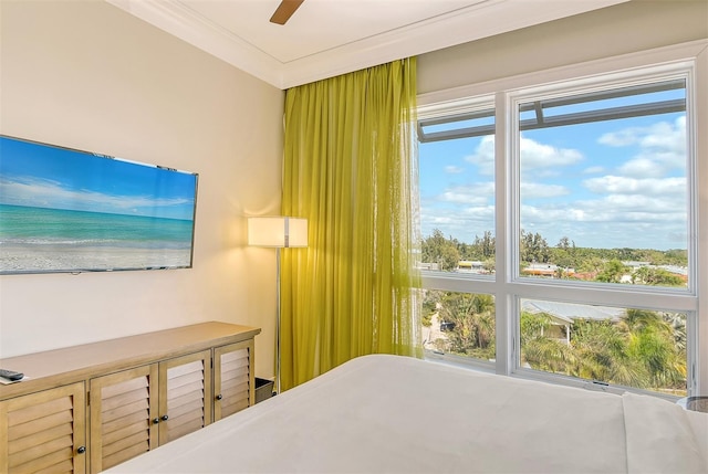 bedroom with multiple windows, ornamental molding, and a ceiling fan