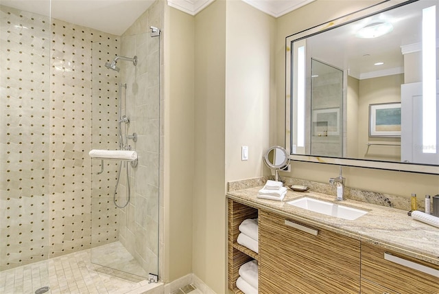 bathroom featuring a stall shower, vanity, and ornamental molding