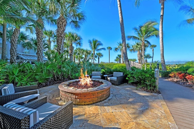 view of patio with a fire pit and fence