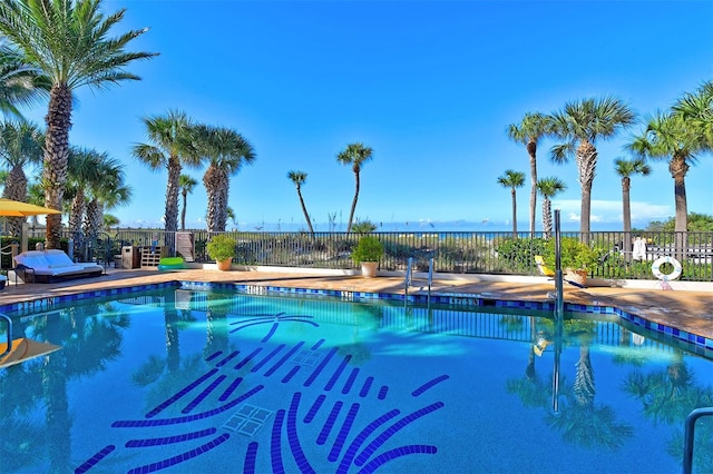 community pool with a patio and fence