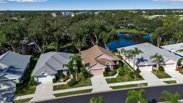 bird's eye view featuring a residential view and a water view