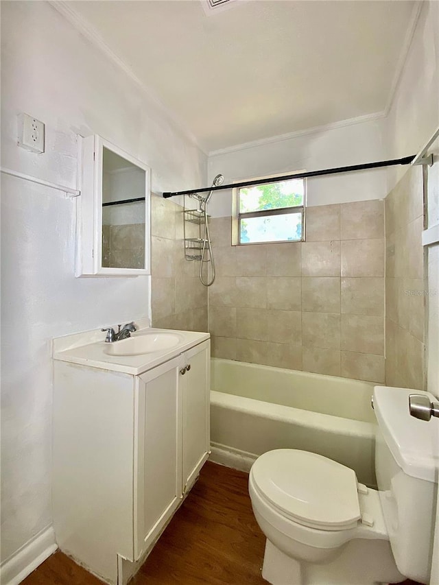 bathroom with wood finished floors, toilet, vanity, and washtub / shower combination
