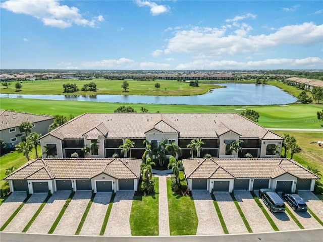 birds eye view of property with view of golf course and a water view