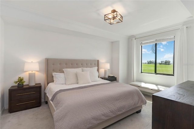 bedroom featuring crown molding and light colored carpet