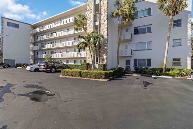 view of building exterior with uncovered parking