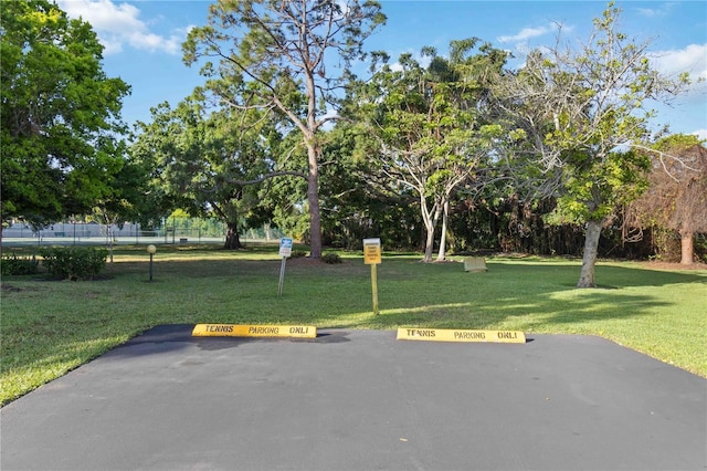 exterior space featuring uncovered parking and a yard
