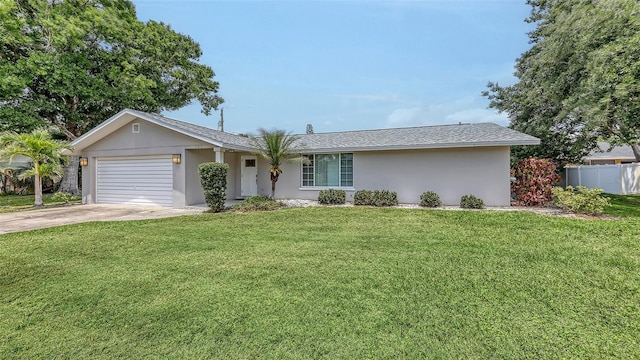 ranch-style house with stucco siding, fence, a front yard, concrete driveway, and an attached garage