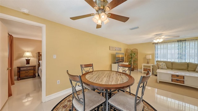 dining space with a ceiling fan, visible vents, and baseboards