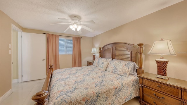 bedroom featuring a textured ceiling, a ceiling fan, and baseboards