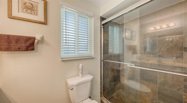 full bathroom with a stall shower and toilet