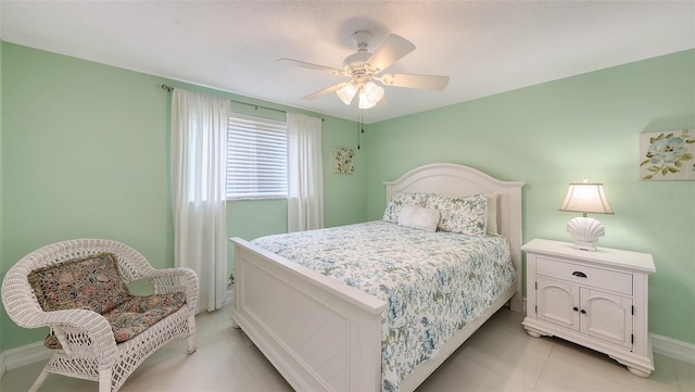 bedroom featuring light tile patterned flooring, ceiling fan, and baseboards