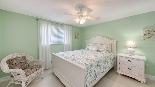bedroom featuring light tile patterned floors, ceiling fan, and baseboards