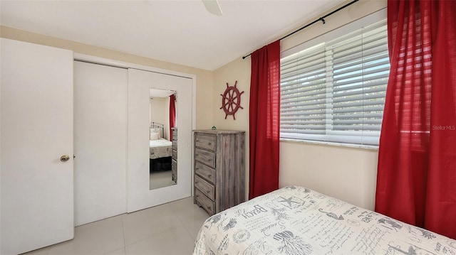 tiled bedroom with a ceiling fan