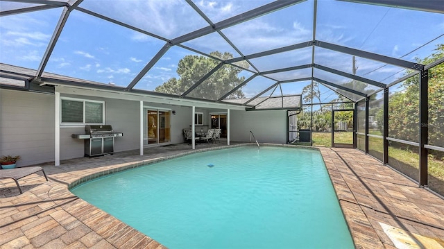pool featuring a grill, a patio, and a lanai