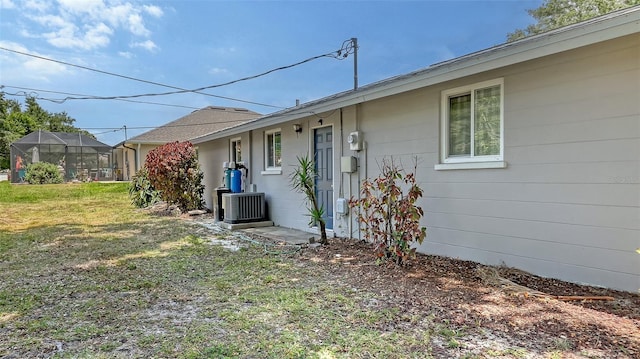 view of property exterior featuring a lawn and central air condition unit