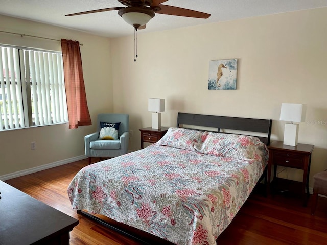bedroom with a ceiling fan, baseboards, and wood finished floors