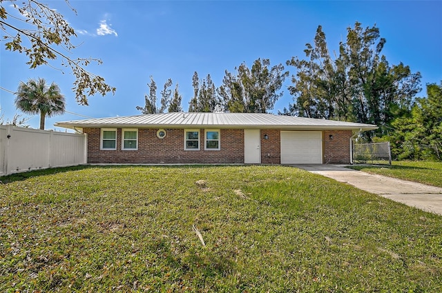 single story home with fence, a front lawn, brick siding, a garage, and a standing seam roof