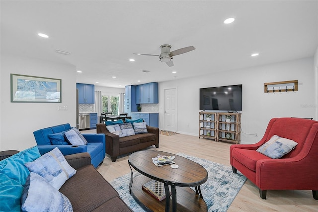 living area with a ceiling fan, recessed lighting, and light wood finished floors